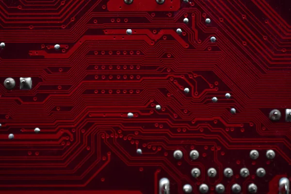 Red computer Motherboard Chips close-up with Contacts