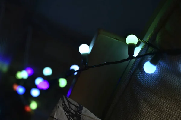 Colorful light bulbs on the palace of the house and on the wall