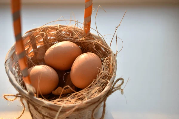 Knitted basket with red eggs on a white background