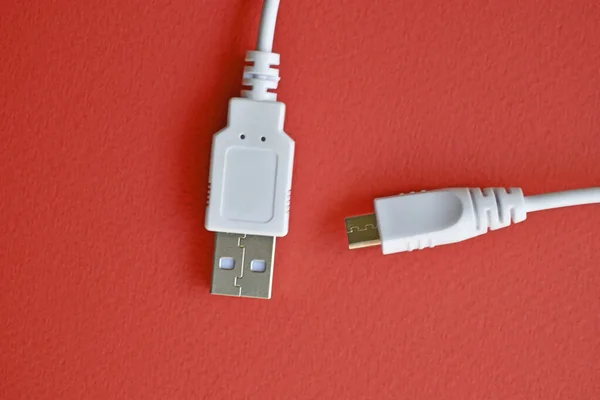 White USB PC cable on red background