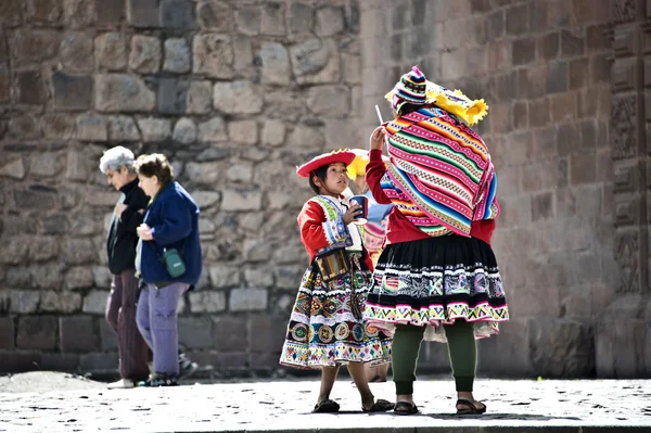 Quechua Indians break from posing with tourists — Stock Photo, Image