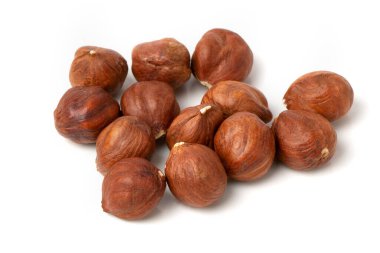 Close-up of hazelnut kernels on a white background.