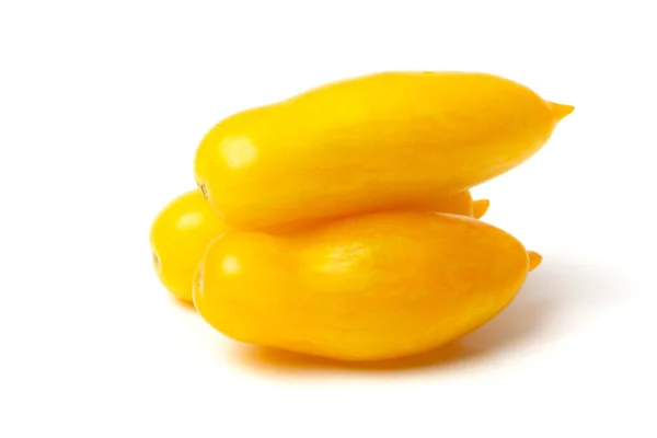 Three Elongated Yellow Tomatoes Lie White Background — Stock Photo, Image