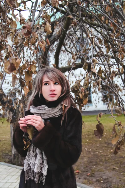 Girl near the tree branches — Stock Photo, Image