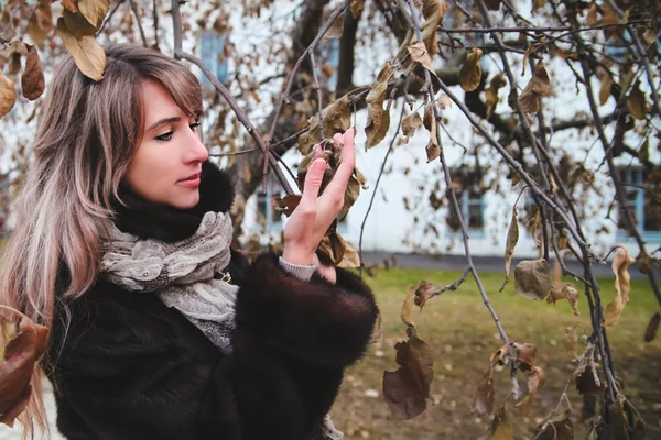 Girl near the tree branches — Stock Photo, Image