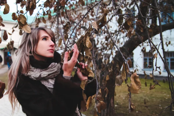 Girl near the tree branches — Stock Photo, Image