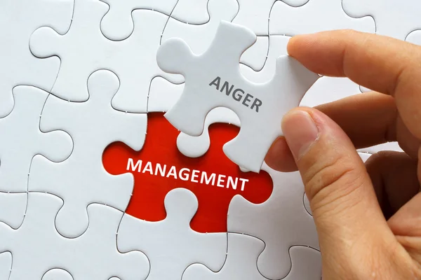 Piece of blank jigsaw puzzle with word ANGER MANAGEMENT. — Stock Photo, Image