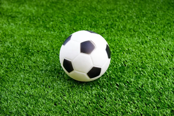 Toy ball on artificial grass background — Stock Photo, Image