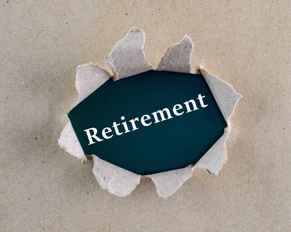 Torn brown rough textured paper with "Retirement" word at background surface. — Stock Photo, Image