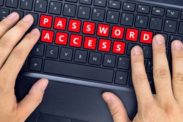 Mãos no laptop com palavras "PASSWORD ACCESS" nos botões do teclado . — Fotografia de Stock