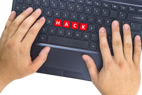 Hænder på laptop med "HACK" ord på tastaturknapper på hvid baggrund . - Stock-foto
