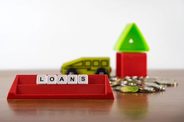 Conceptual photo of word "Loans" spelled by alphabet blocks arrangement. — Stock Photo, Image