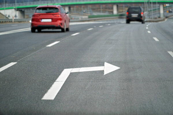 White Arrow Sign is Painted on the Asphalt Surface