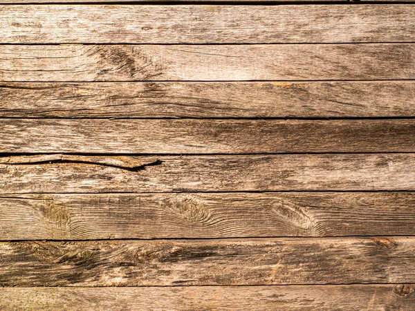 The texture of the old wall from a wooden horizontal board. Wooden plank. Wood texture. A branch in a tree. Joinery. Building sector. Sawmill materials. Retro style. Background image. Background.