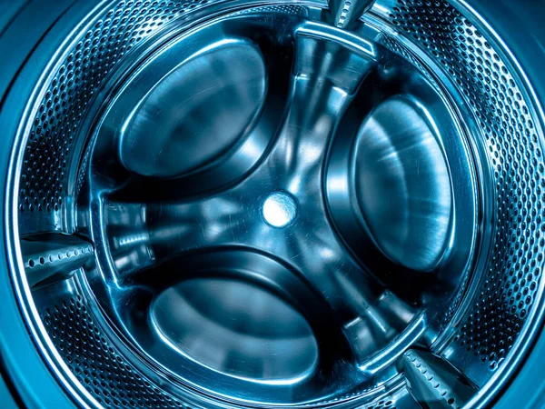 Metal drum of the washing machine made of stainless steel. Stainless steel tank. Washing machine repair service. Household appliances repair workshop. Mechanic repairman. Home wash.