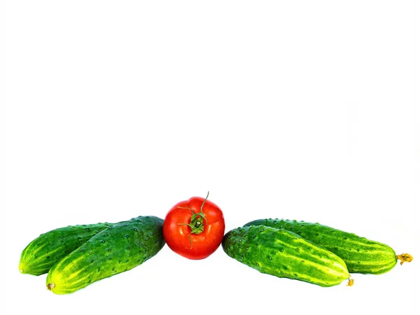 Vegetables red tomatoes and cucumbers on a white background. — Stock Photo, Image