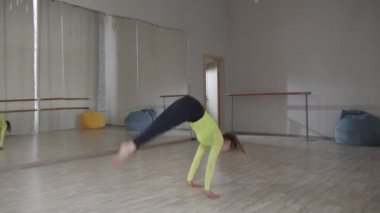 Modern dans okulundaki genç bir kızın göz kamaştırıcı dansı. Çağdaş dansta Randat atlayışı ve ters takla.