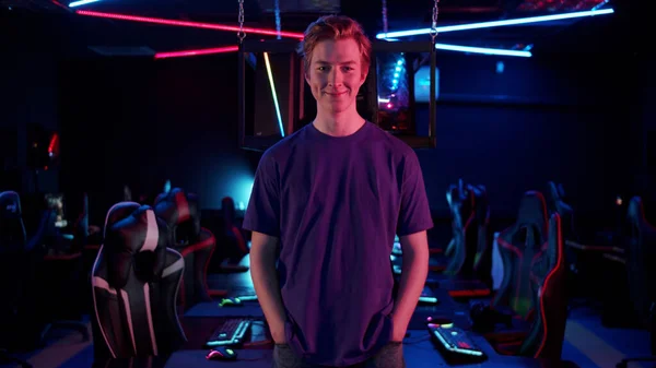 A gamer guy poses for a video presentation of his cyber team at the upcoming online video games championship