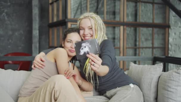 Grávida lésbicas casal mostrando ultra som imagem no quarto — Vídeo de Stock