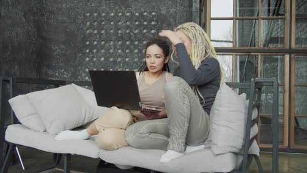 Lesbian couple discussing new law about LGBT rights while using internet — Stock Video