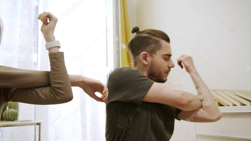 Two people are doing arm exercises