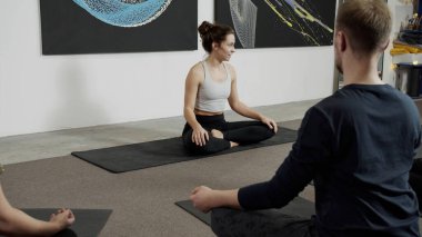 Nilüfer yogası yapan bir grup insan ders bittikten sonra poz veriyor. 