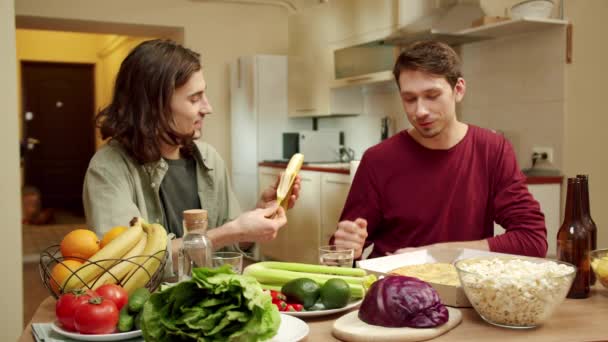 一个朋友在吃香蕉，另一个在吃披萨 — 图库视频影像