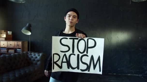 Młodzieniec z transparentem na protest, rajd lub kampanię uświadamiającą przeciwko dyskryminacji rasowej — Wideo stockowe