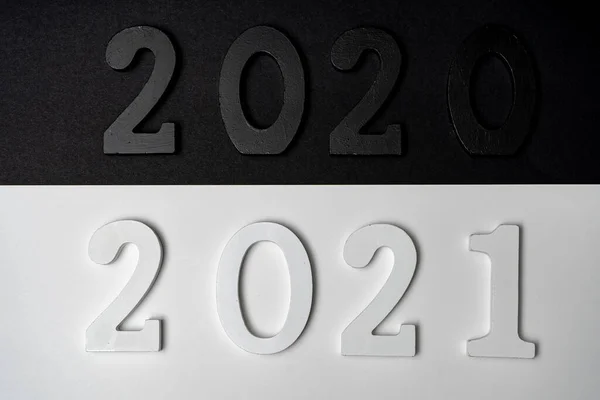 Conceptual image of the transition from a black 2020 to a 2021 depicted in white with the hope that it will be a good year. Hope concept