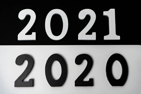 Conceptual image of the transition from a black 2020 to a 2021 depicted in white with the hope that it will be a good year. Hope concept