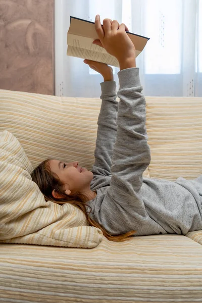 Cute Little Girl Reading Book Interest Sofa Her Living Room — Stock Photo, Image
