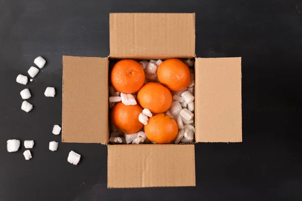 Delivered orange fruit in a delivery box.