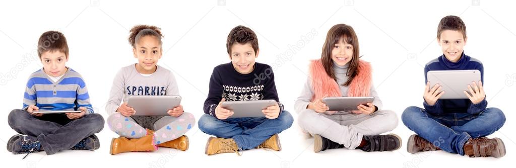 Little kids  playing with tablets