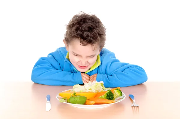 Little boy eating vegetables — Stock Photo, Image