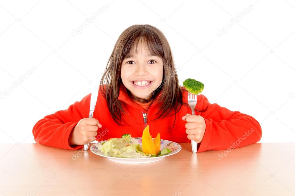 Little girl eating vegetables