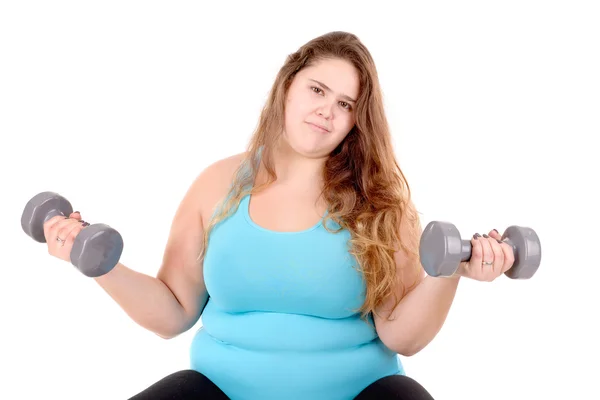 Fat girl in fitness clothes doing exercise with dumbbells on mat at home.  fitness concept for good health. weight control. fat belly, healthy body,  yoga 13095327 Stock Photo at Vecteezy