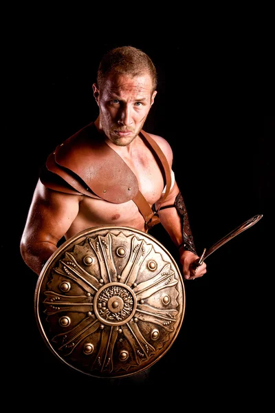 Gladiator isolated in dark — Stock Photo, Image