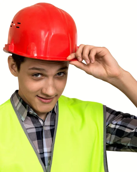 Joven constructor en chaleco y casco sobre un fondo blanco —  Fotos de Stock