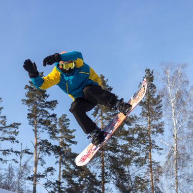 Mavi gökyüzü uçan snowboarder