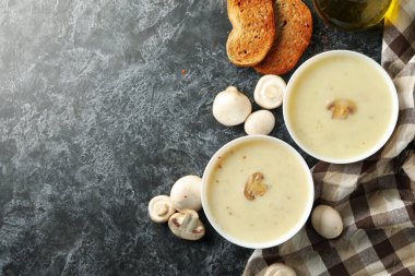 Siyah dumanlı arka planda bir kase mantar çorbası ile lezzetli öğle yemeği kavramı