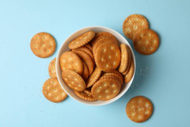 Mavi arka planda lezzetli kraker bisküvileri olan kase