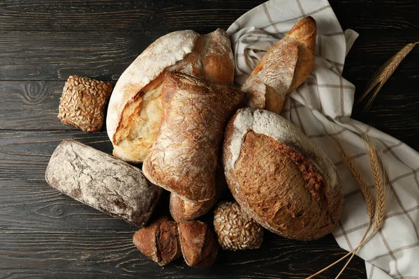 Different fresh bakery products on wooden background