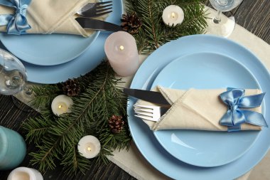 Ahşap masa üzerinde mumlar olan romantik yeni yıl sofrası konsepti