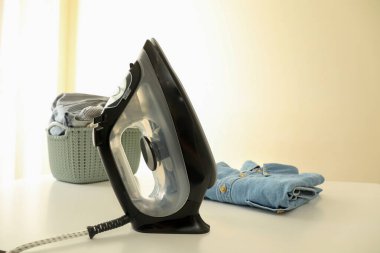 Modern demir ve çamaşır beyaz masada.