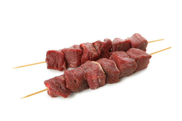 Skewers with raw meat isolated on white background