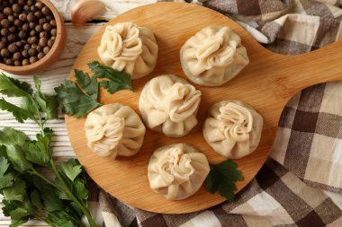 Beyaz ahşap arka planda khinkali tahtası ile lezzetli öğle yemeği kavramı