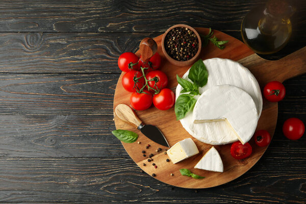 Concept of tasty eating with camembert and spices on wooden background