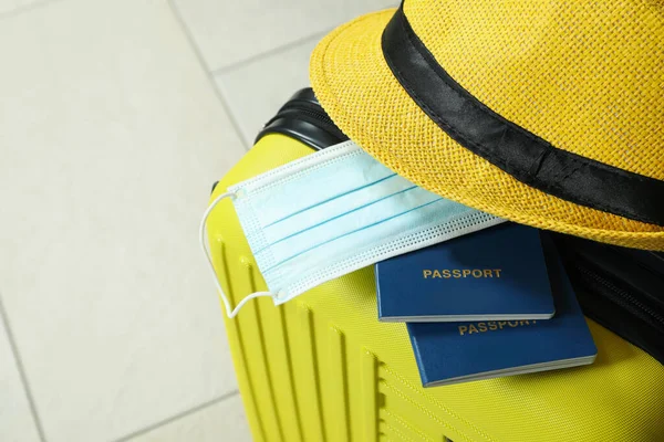 Travel bag with passports, medical mask and hat