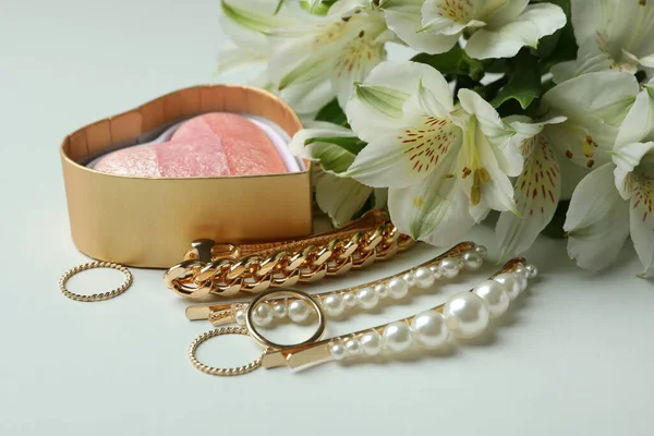 Female concept with jewelry and flowers on white background