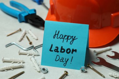 Beyaz desenli arka planda farklı aksesuarlarla Mutlu İşçi Bayramı kavramı